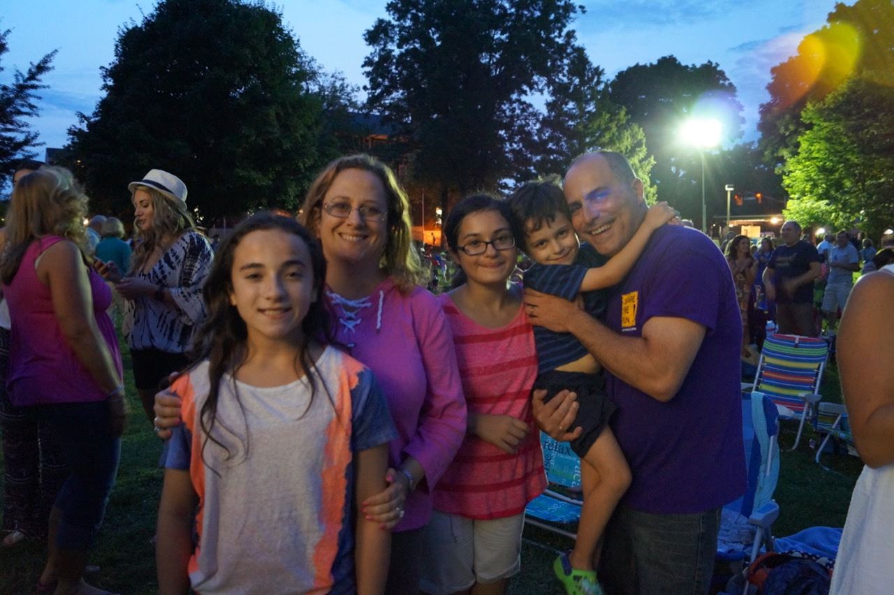 A family enjoys the band at the Brian Kirk and the Jirks - Hot Summer Nights event.